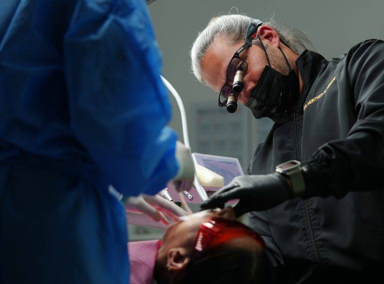 Dentist doing Oral Surgery